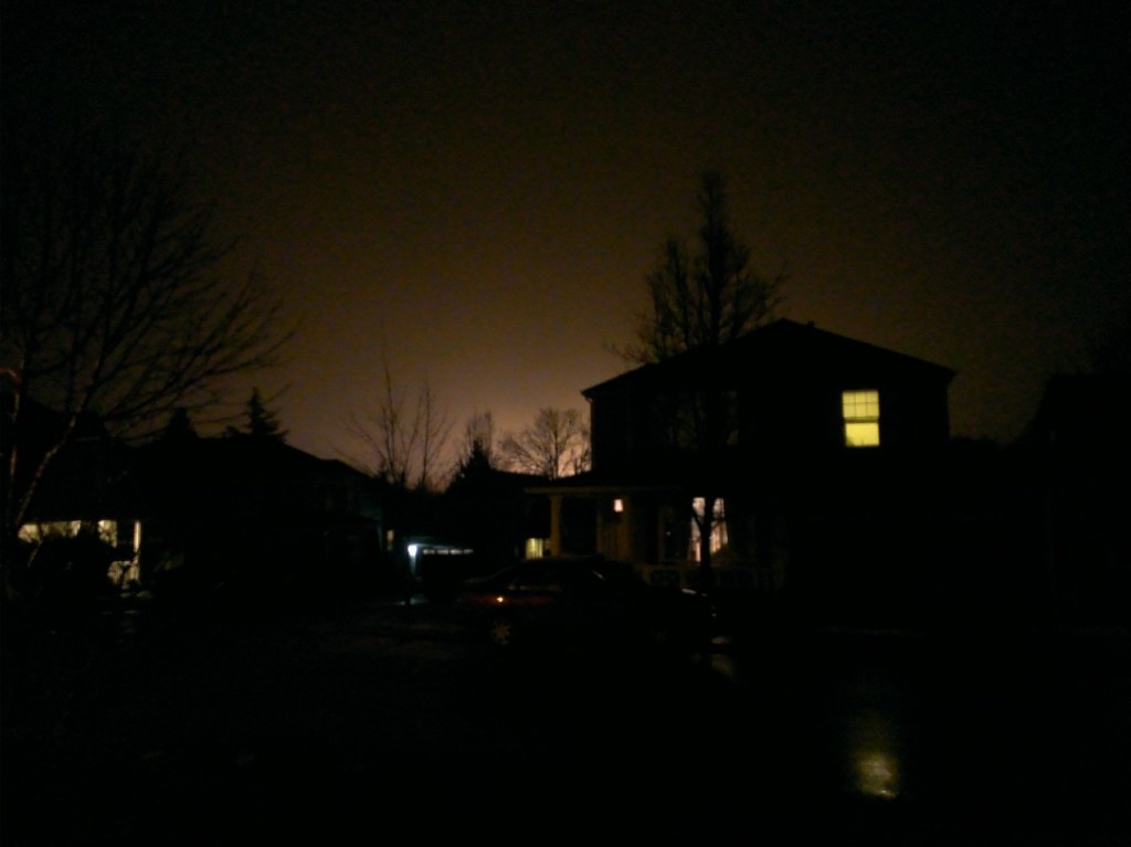 At night, with the sky illuminated by the neighboring High School football field lights